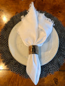Natural Guinea feather placemat styled beneath a place setting