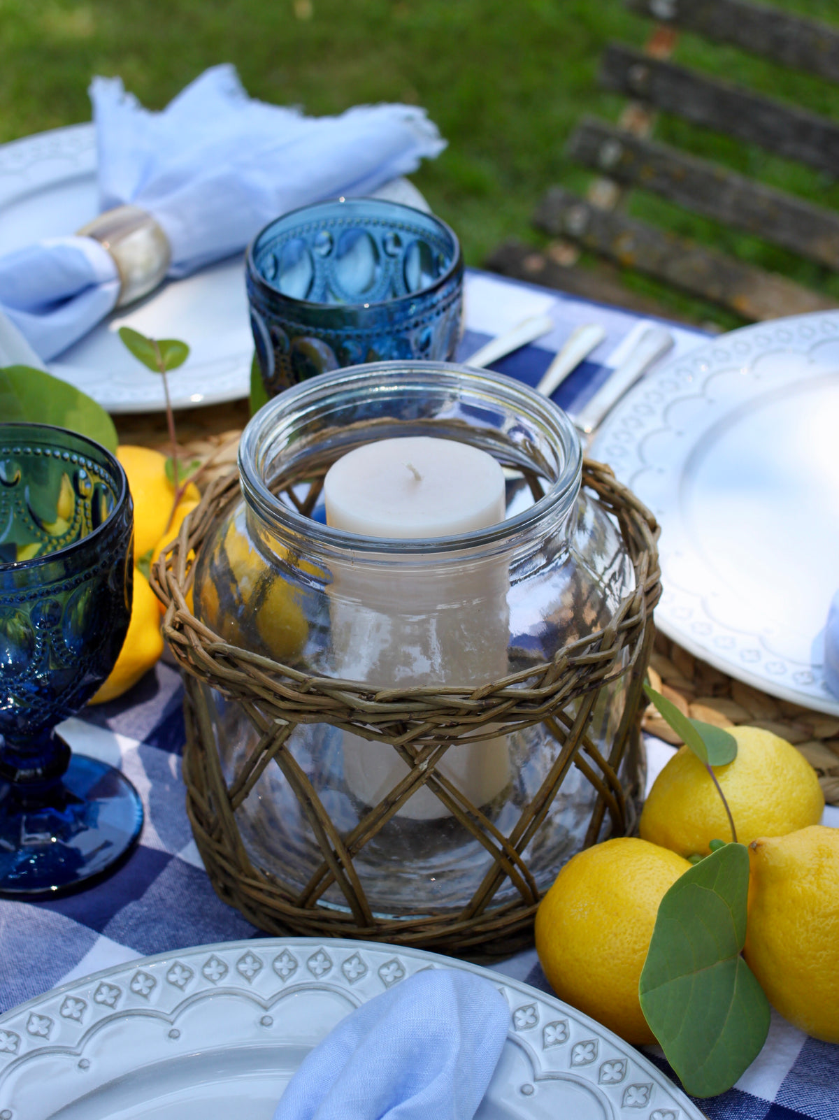 Wicker basket hurricane styled with candlelight for entertaining