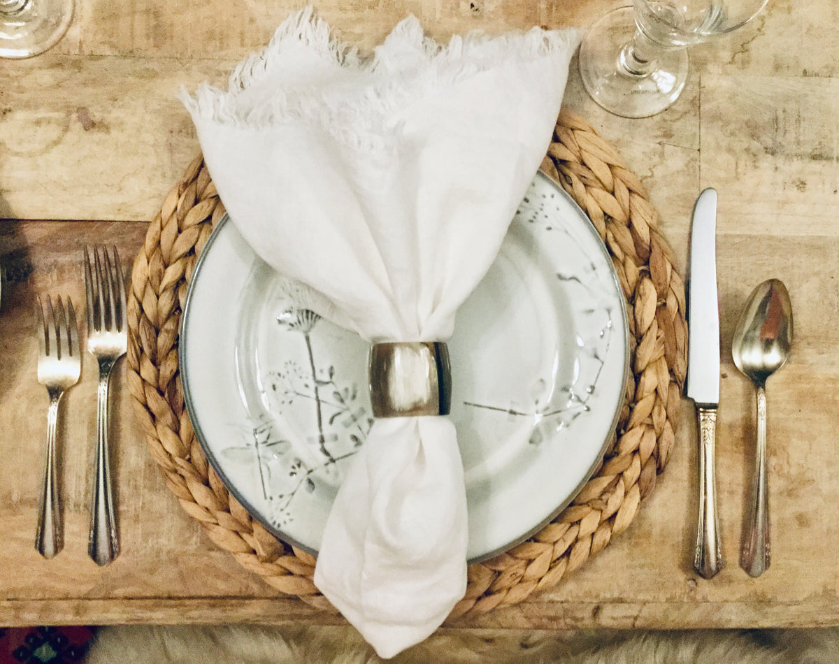 Classic white linen napkins styled with tabletop accents