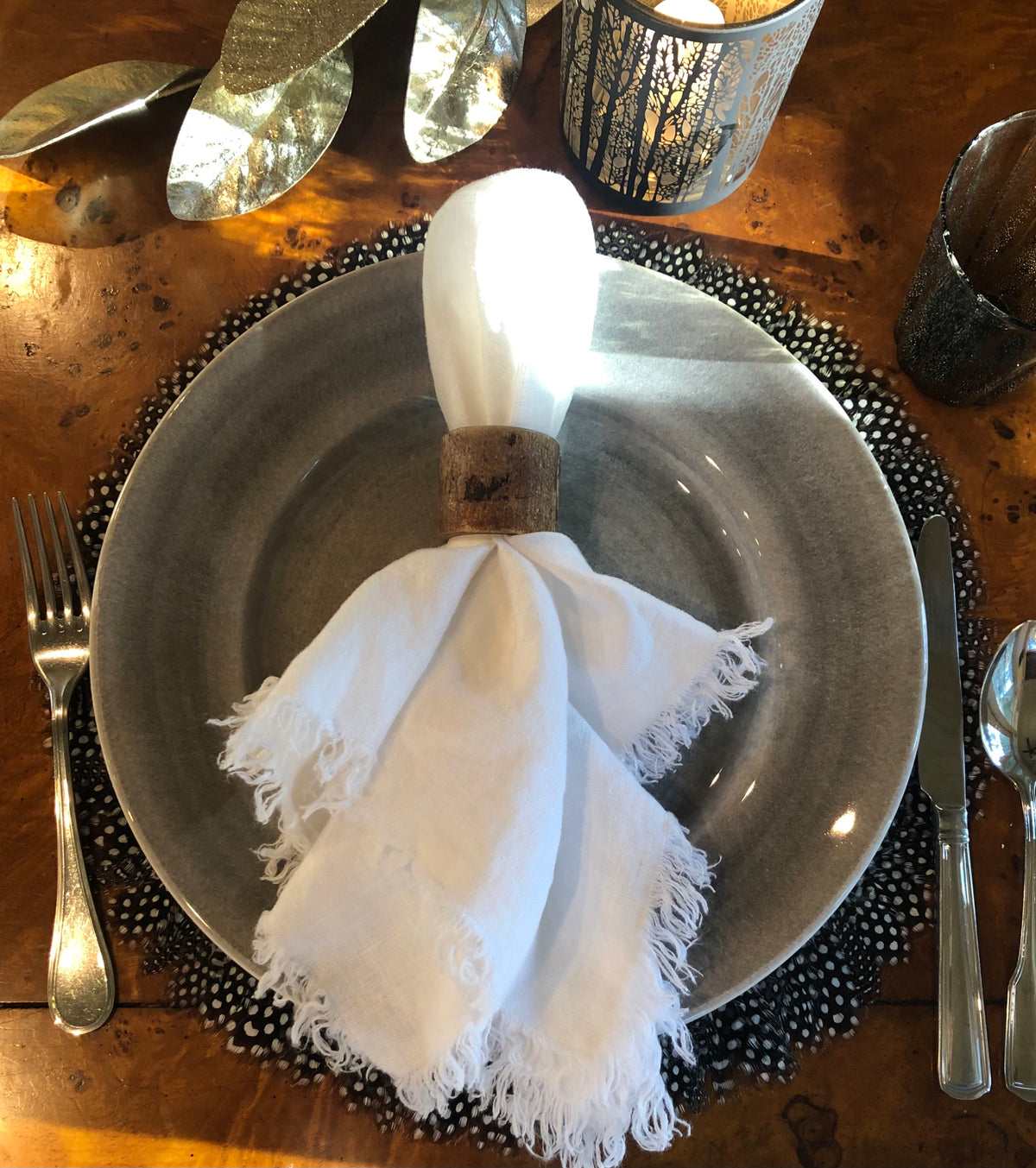 Black-and-white Guinea feather placemat adding texture to a dining table