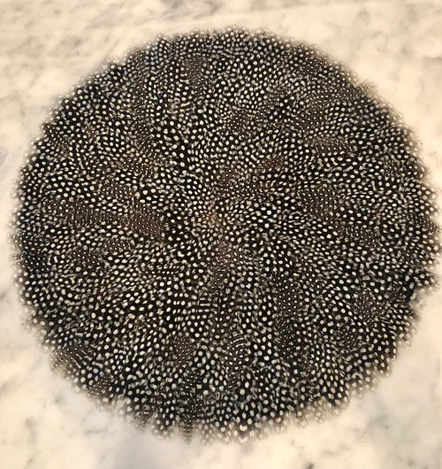 Guinea feather placemat with natural black-and-white pattern