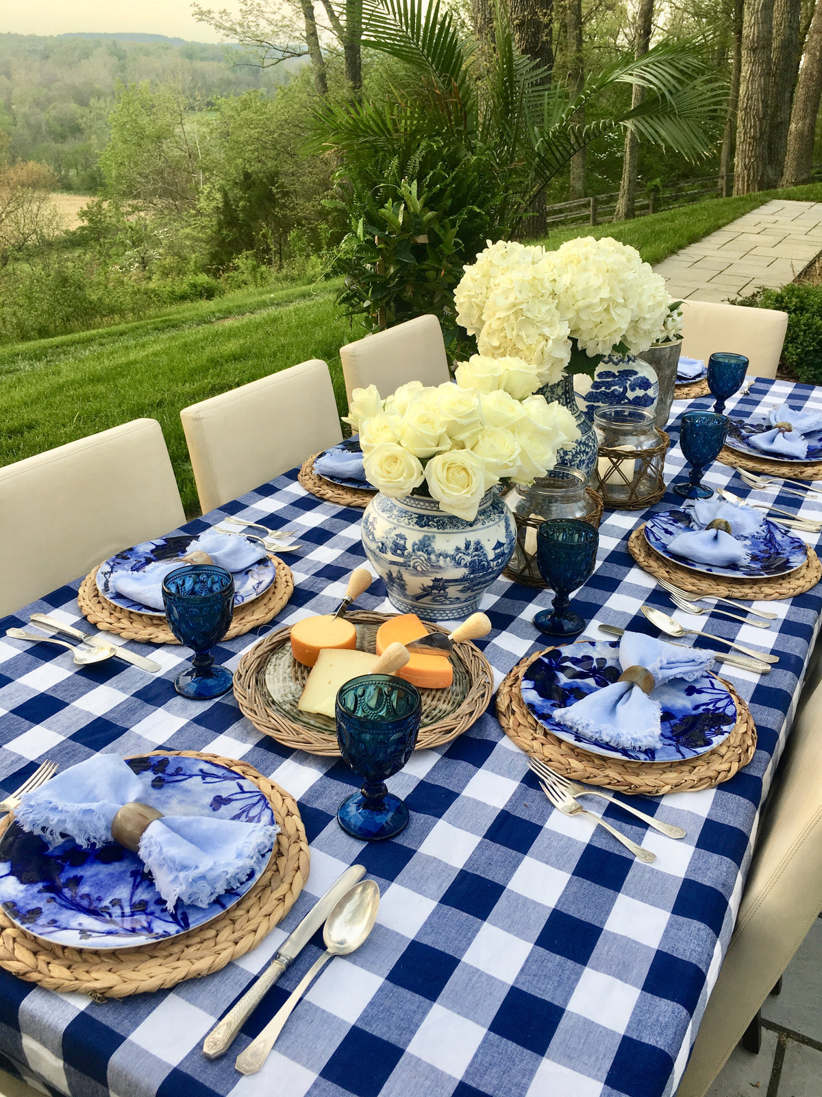 Layered blue-and-white place settings with vases from the You Blue Me Away tablescape kit