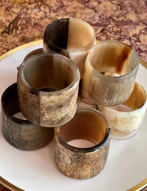 Set of eight natural horn napkin rings for an elegant layered table