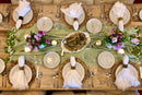 White stonewashed linen napkins folded for an elegant place setting